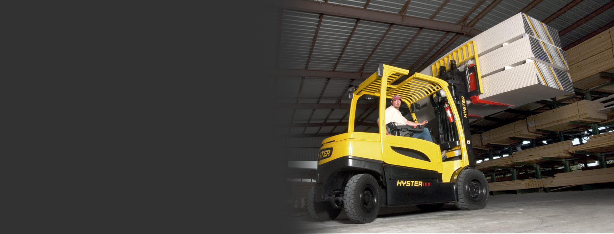 Yellow Hyster forklift lifting wood