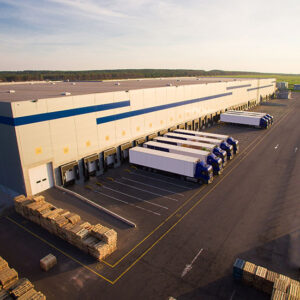 distribution warehouse loading dock rows of doors and shelters and trucks logistics