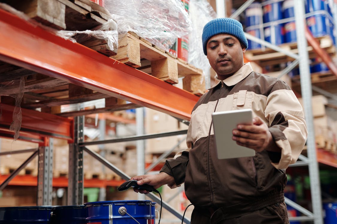 (4) work in progress goods Warehouse worker with a clipboard.