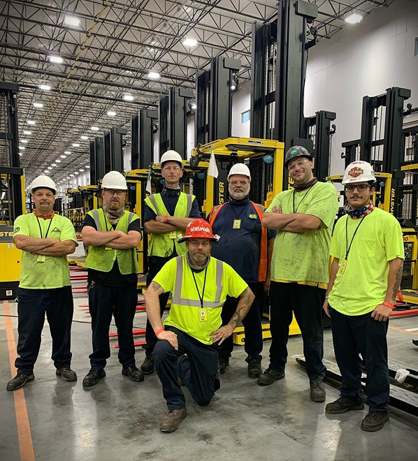 Dundalk-Technicians-Pose-Inside-Warehouse-After-Completing-Major-Installation Eastern Lift Truck Co. Dundalk Technicians posing in a warehouse after completing a large new equipment installation job.